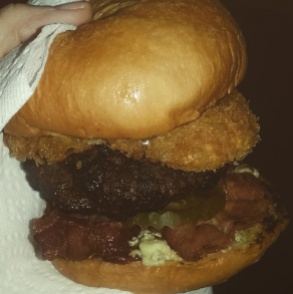 Bacon cheeseburger with bleu cheese, BBQ sauce, and onion rings
