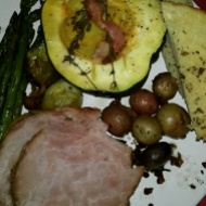 Christmas dinner of roast acorn squash, garlic bread, honey and mustard-crusted ham, asparagus, brussels, and pan-fried potatoes. Pretty much everything has bacon on it.