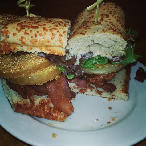 Fried green tomato BLT on caramelized onion and herb bread